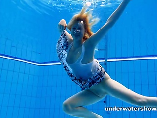 Cute Lucie is stripping underwater